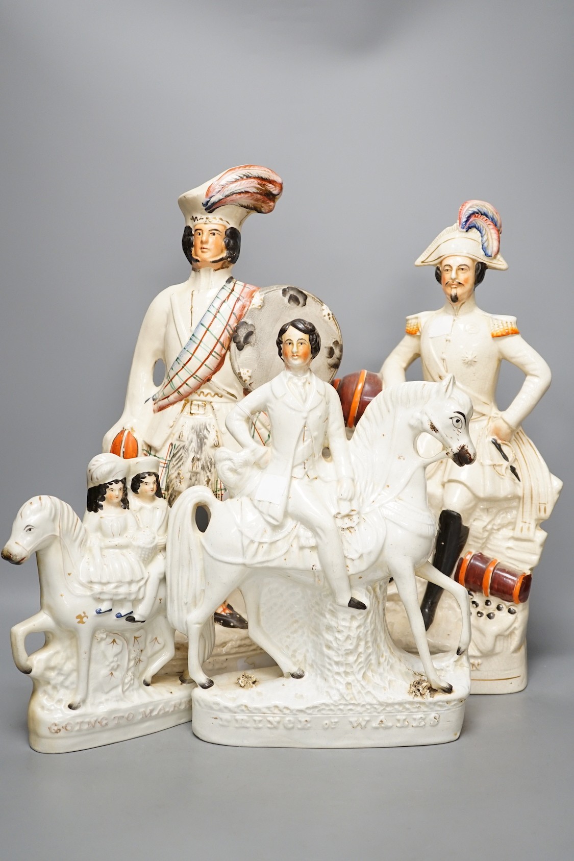 A group of Staffordshire including cottages and flatbacks